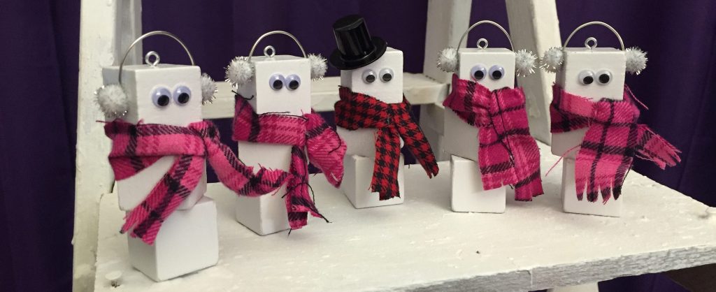 Wood block snowmen in a line